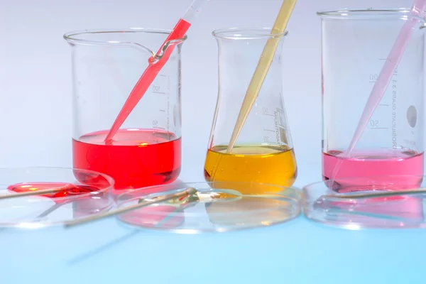 Glass laboratory apparatus with color water — Stock Photo, Image