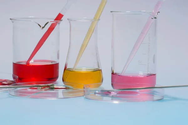 Glass laboratory apparatus with color water — Stock Photo, Image