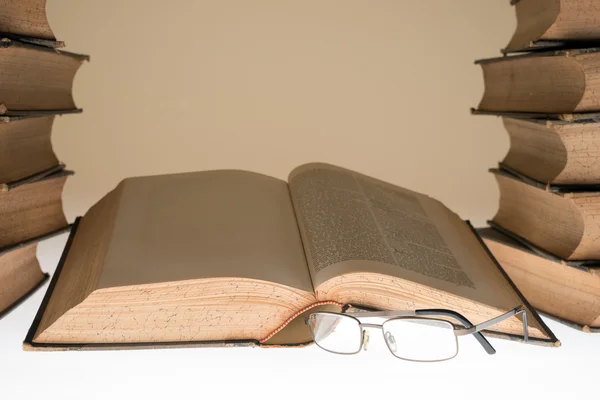 Open old book and glasses on table — Stock Photo, Image