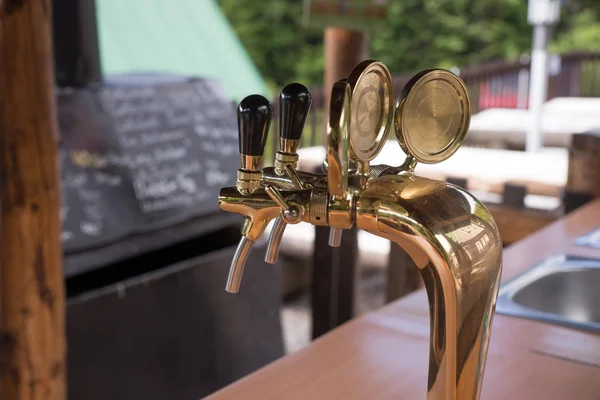 Golden beer taps at the bar — Stock Photo, Image