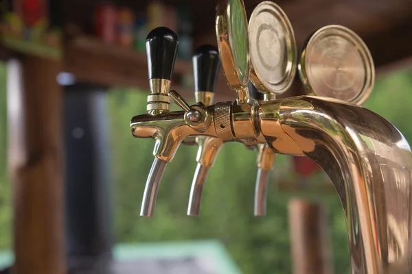 Golden beer taps at the bar — Stock Photo, Image