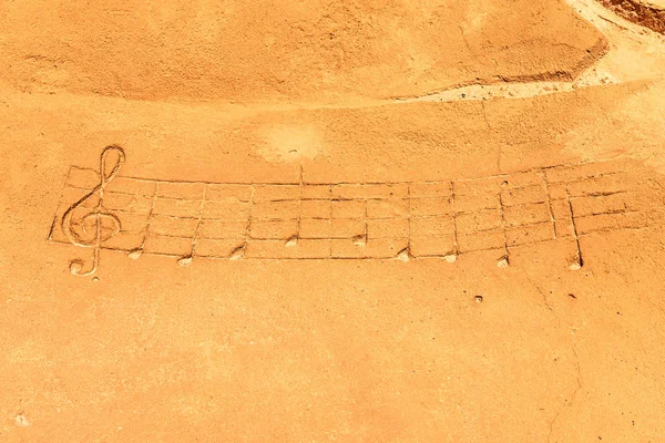 Drawn musical notes on sand — Stock Photo, Image