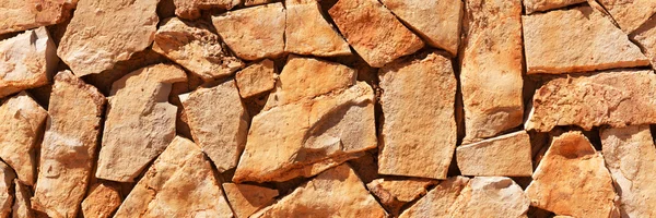 Wall of brown natural stones — Stock Photo, Image