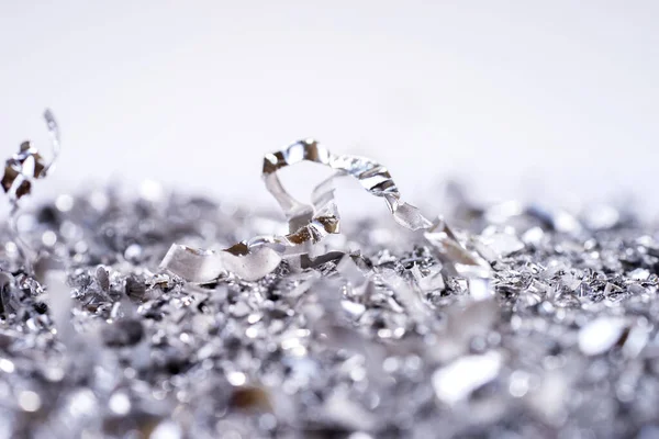 Metal shavings. Background of metallic chips. Processing of ferrous metals in a factory. Metal background
