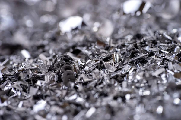 Metal shavings. Background of metallic chips. Processing of ferrous metals in a factory. Metal background