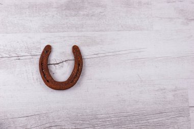 Parlak ahşap arka planda izole edilmiş paslı at nalı. İyi şanslar sembolü. Üst görünüm