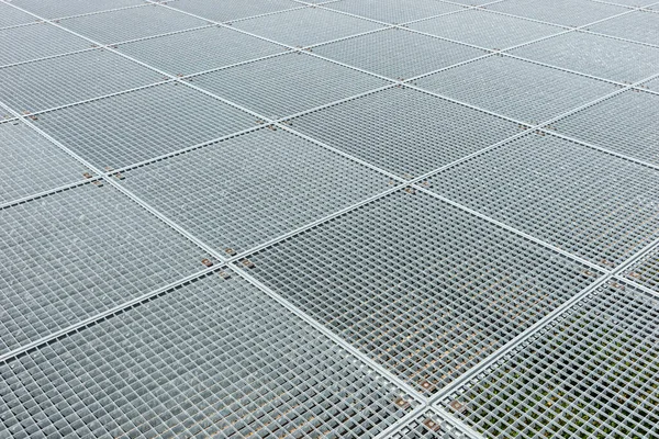 Grating platform. Square industrial galvanized metal grid. Metal background