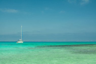 Beyaz kum, mavi su, tekne, sahil, Chrissi adası. Yunanistan