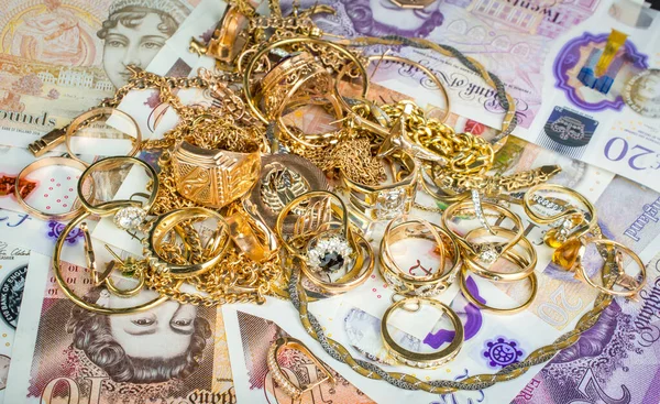 pile of gold money of united kingdom english pounds UK money on black background