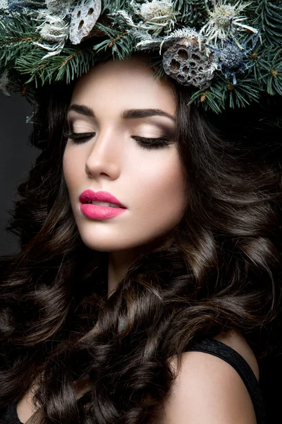 Beautiful girl with winter wreath. — Stock Photo, Image