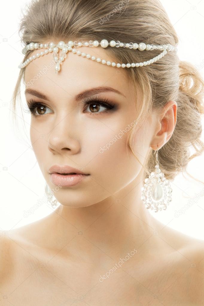 Portrait of the bride with beautiful hairstyle on white background