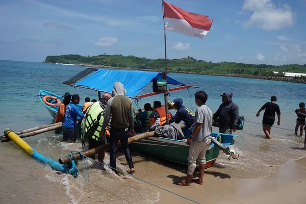 stock image Blitar, East Java, Indonesia - April 7th, 2020: People on the boat. They spend their holiday on tambakrejo beach, Blitar, East Java, Indonesia