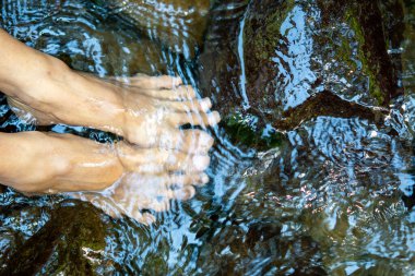 Ayaklarını soğuk dağ suyuna batırıyorsun. Egzersizden sonra kas ağrısını ve iltihabı azaltır, kan dolaşımını hızlandırır ve enerjiyi artırır..