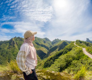 Beautiful Asian travelling to Kelud mountain in Indonesia. Mountain with blue sky background.