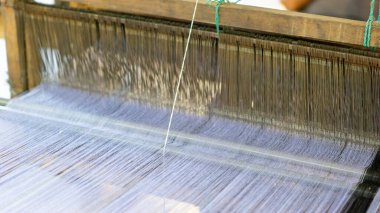 İplikler düzgünce dizilmiş geleneksel örgü makineleridir. Dokuma kumaşı (tenun) Endonezya 'nın ünlü bir kumaşıdır..