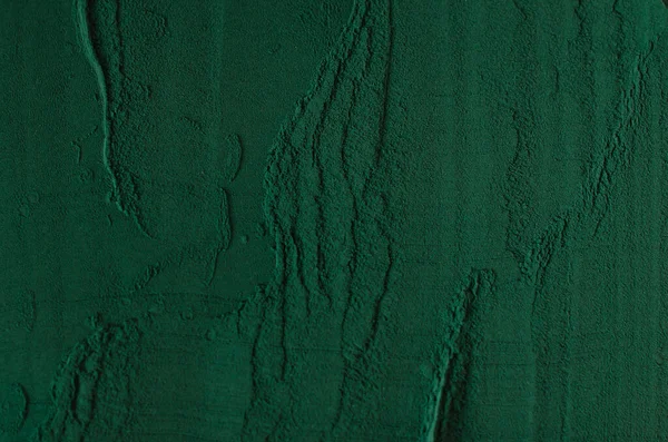 Background from Spirulina powder. Pattern. View from above.