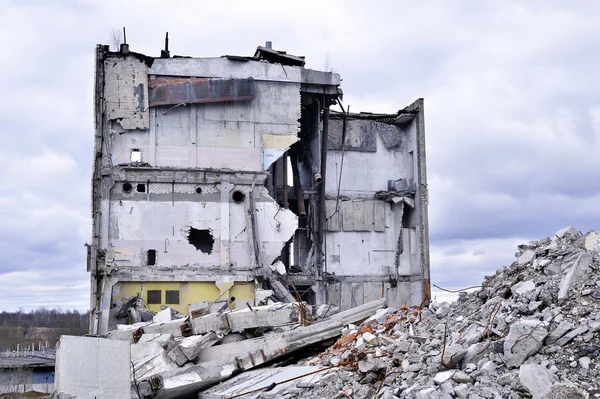 Pezzi di metallo e pietra si stanno sgretolando dall'edificio demolito — Foto Stock