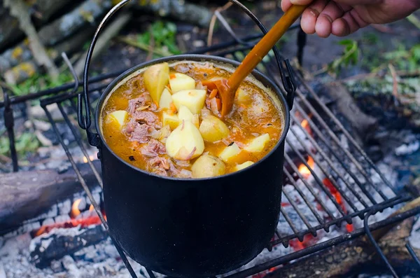 The cooking of soup on the fire