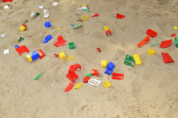 Children\'s sandbox with toys scattered