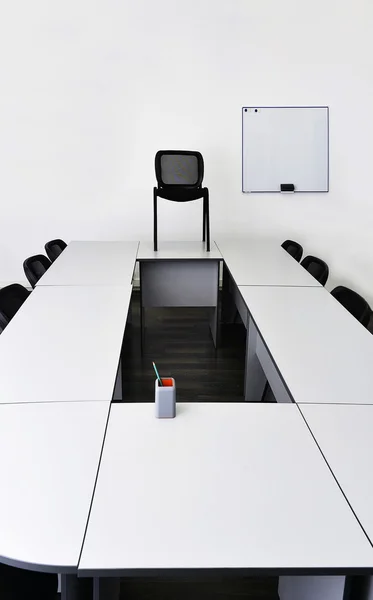 Empty meeting room in the office with tables and chairs