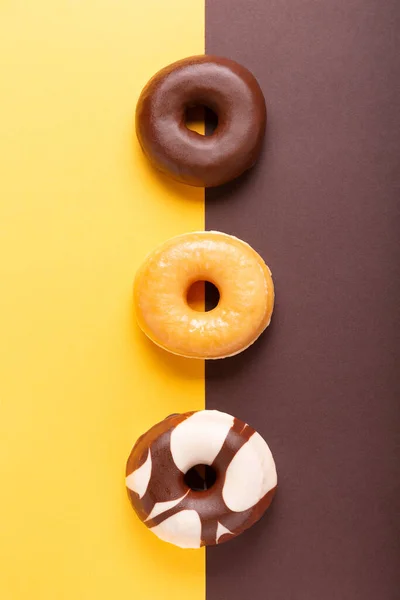 Flat Lay Composition Three Donuts Brown Yellow Background — Stock Photo, Image