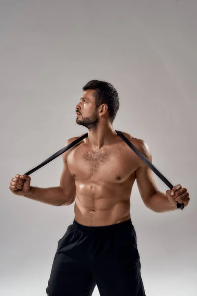 Young shirtless caucasian sportsman with elastic rubber — Stock Photo, Image