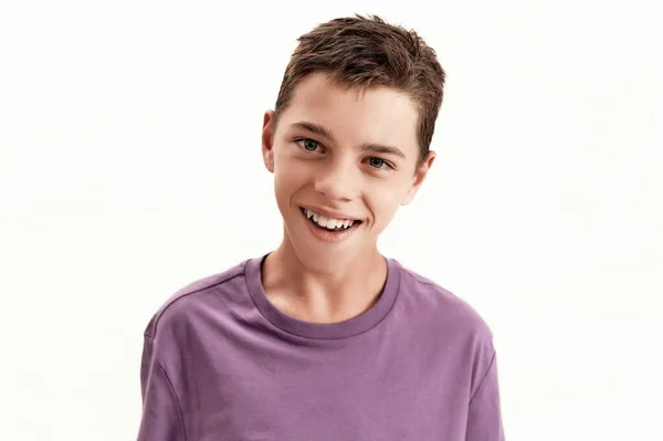 Close up portrait of happy teenaged disabled boy with cerebral palsy smiling at camera, posing isolated over white background — Stock Photo, Image