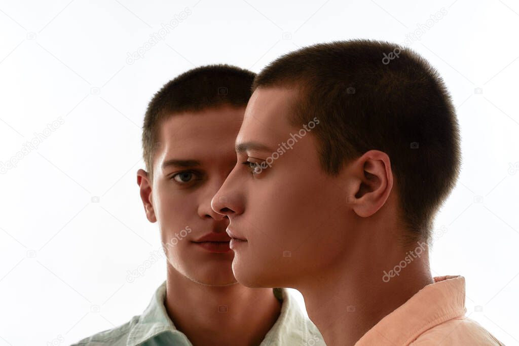 Family relationships concept. Front and side view of two young caucasian twin brothers