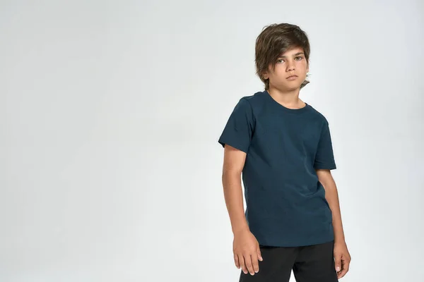 Little sportive boy child in sportswear looking at camera, while standing isolated over white background — Stock Photo, Image