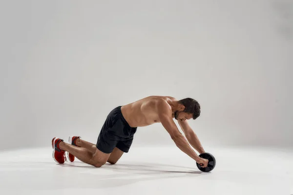 Young handsome muscular caucasian man with abs wheel — Stock Photo, Image