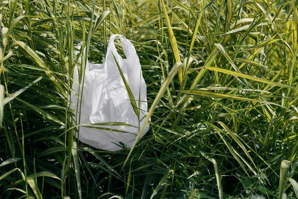 Stop using plastic products. Close up shot of a plastic bag on the green grass in park — Stock Fotó