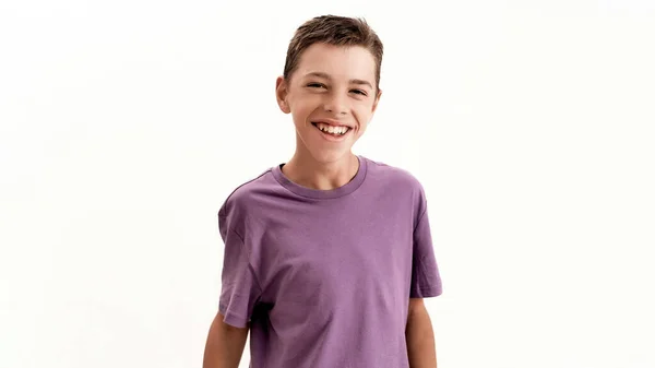 Portrait of happy teenaged disabled boy with cerebral palsy laughing at camera while posing, standing isolated over white background — Stock Photo, Image