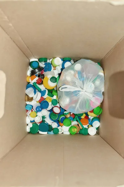 Colorful lids from plastic bottles in box — Stock Photo, Image