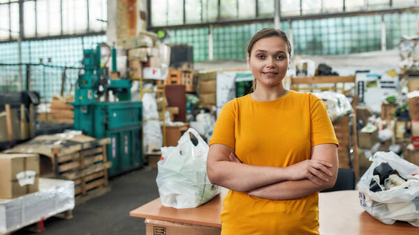 Young caucasian woman standing on garbage station