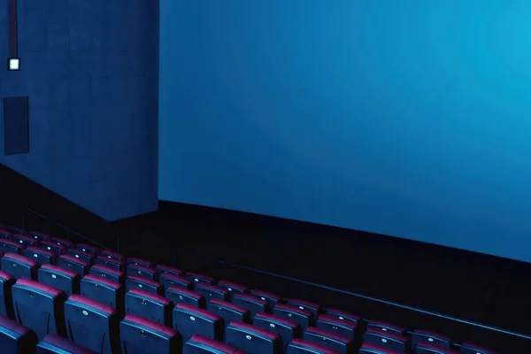 Close-up tiro de interior do auditório de cinema com linhas de cadeiras vermelhas e grande tela branca — Fotografia de Stock