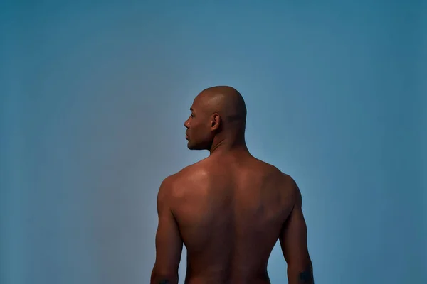 Rear view of a mixed-race person posing in a studio — Stock Photo, Image