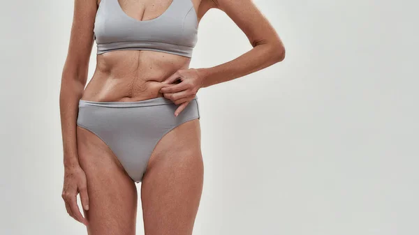 Middle aged caucasian woman in lingerie showing skin — Stock Photo, Image