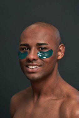 Stüdyoda göz bandı takan mutlu Afro-Amerikalı.