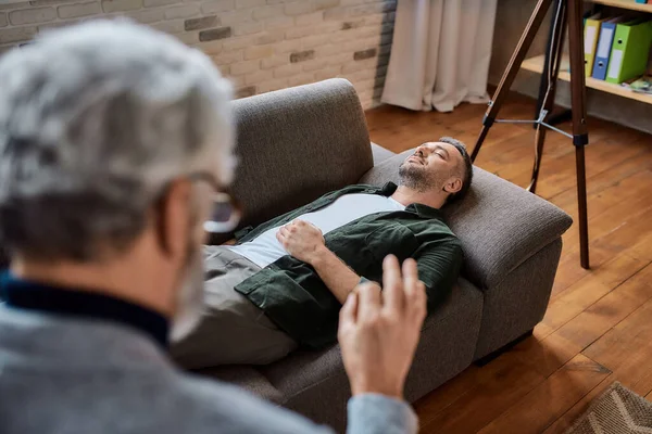 Relaxed patient lying on couch in psychotherapist office