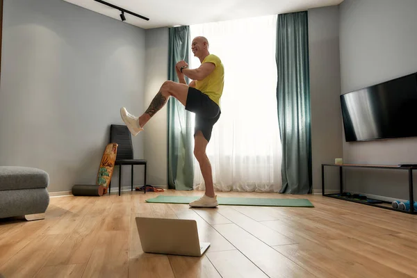 Sports coach works out at home online