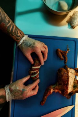 Şef mutfakta tavuk hazırlıyor.