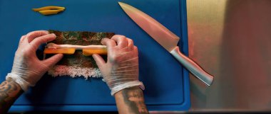 Chef cooking sushi with rice in the kitchen