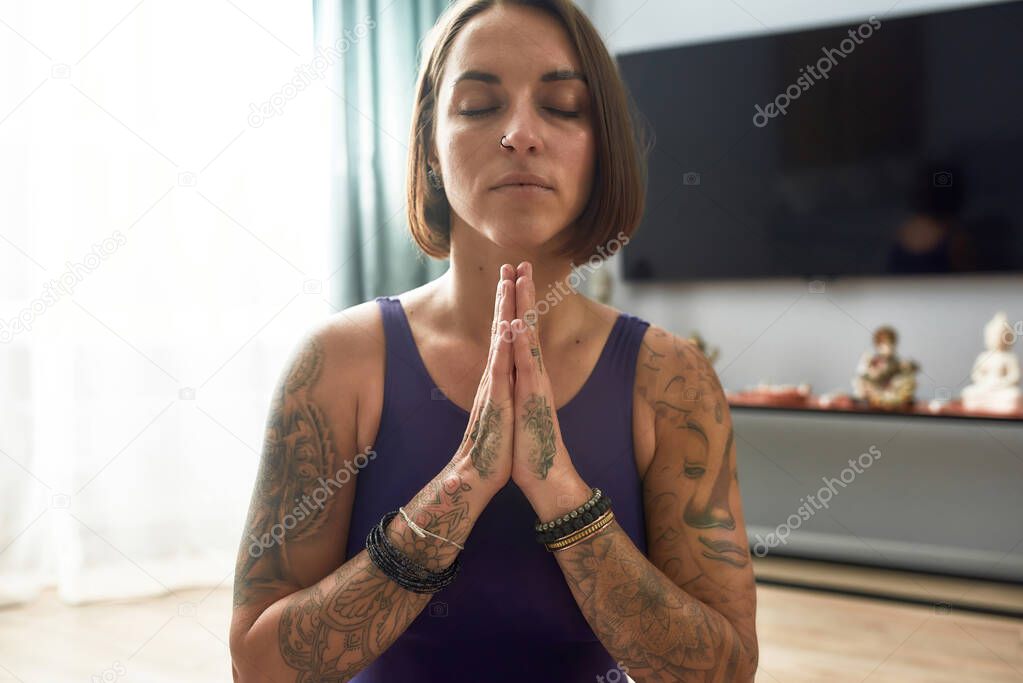 Young girl clasping hands together and praying