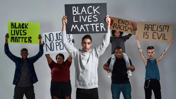 Young gypsy man holding Black Lives Matter poster