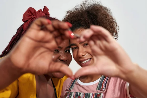 Picture of a two black women making a heart with hands and smiling from inside — Stock Photo, Image