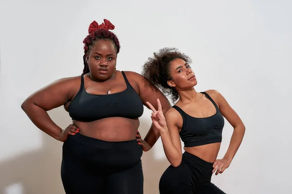 Slim African American Woman in Underwear Sharing a Secret with Her Plus Size  Friend, Standing Together Isolated Over Stock Photo - Image of emotion,  friends: 218940838