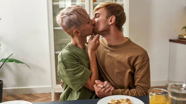 Young caucasian homosexual male couple kissing