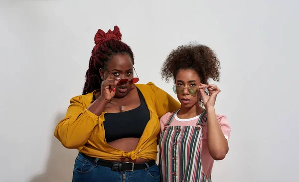Due donne nere che fanno i loro occhiali più bassi — Foto Stock