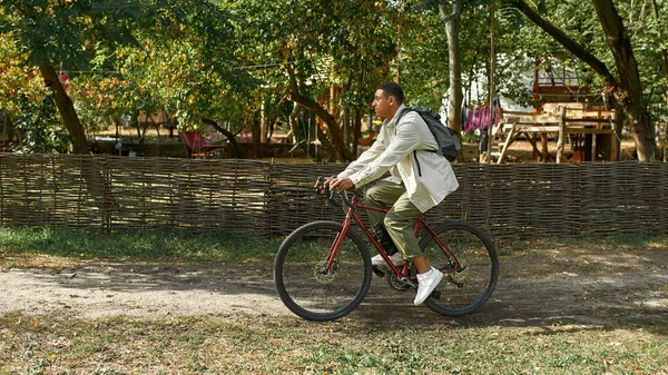 Happy young african american man riding bike — Stock Photo, Image