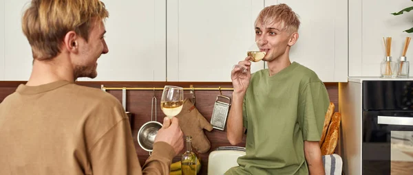 Gay coppia guardando a ogni altro e bere vino — Foto Stock